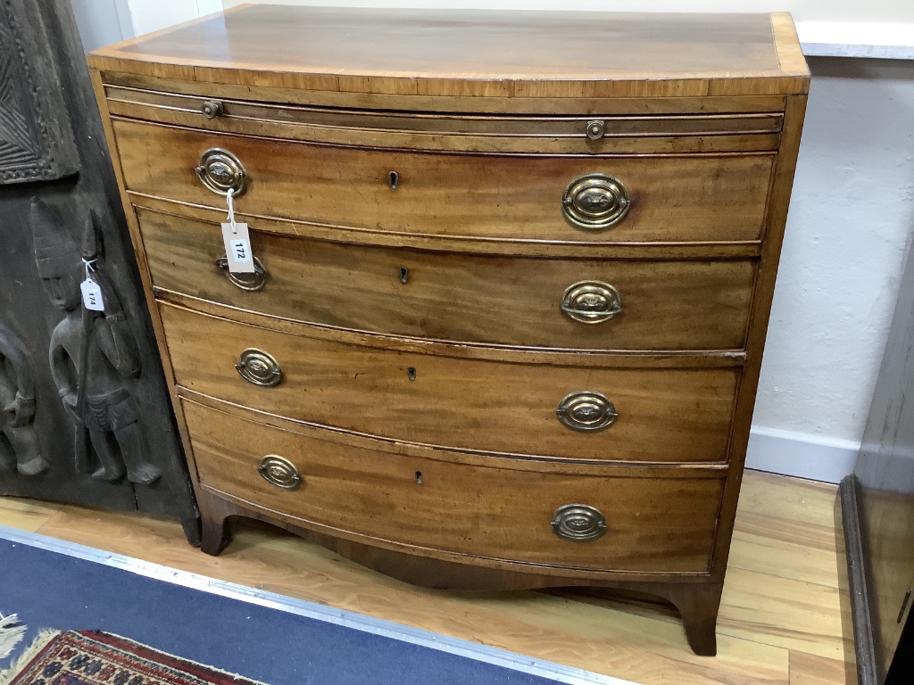 A Regency mahogany satinwood banded bow-fronted chest, fitted brushing slide and four drawers on swept bracket feet, width 92cm depth 51cm height 90cm